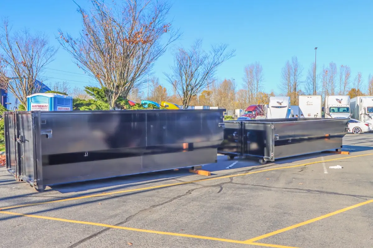 Professional dumpster rental service with roll-off container on residential driveway in Longview